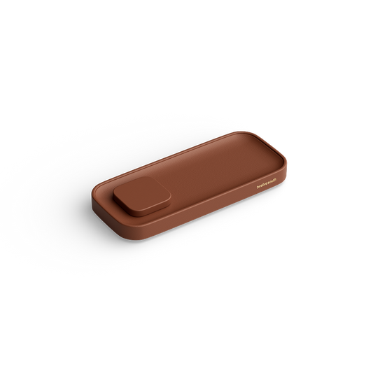 A minimalist rectangular brown leather valet tray with rounded corners and a small matching square charging pad, shown on a clean white background.
