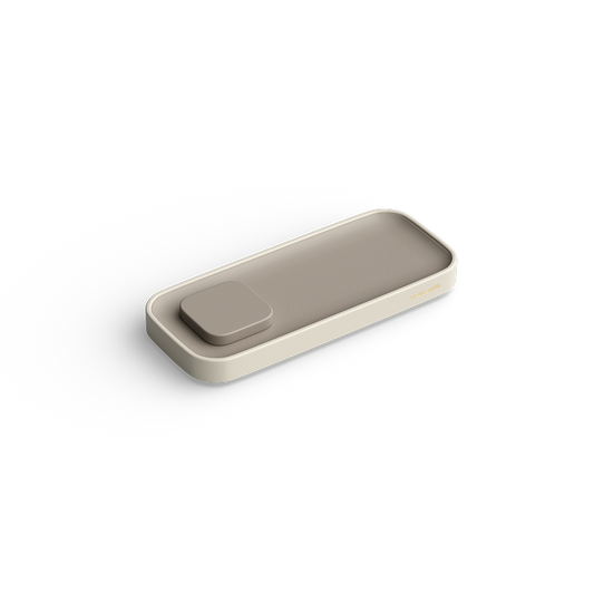 A minimalist rectangular tray with rounded corners and a small square lid on top, shown in a warm beige color on a clean white background.