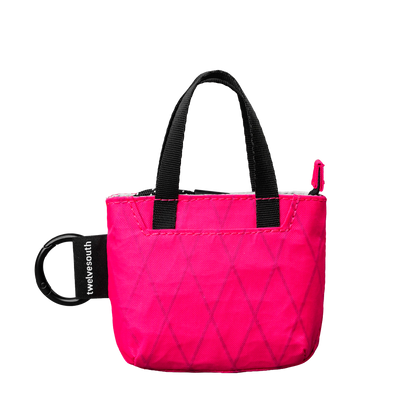 Pink micro tote with black handle on a white background