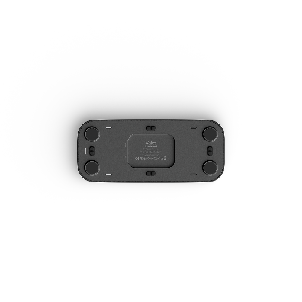 The underside of a black rectangular valet charging tray, showing four circular feet, a central filter cartridge slot, and the 'Vaiet' brand logo, photographed on a clean white background.