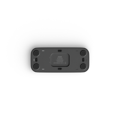 The underside of a black rectangular valet charging tray, showing four circular feet, a central filter cartridge slot, and the 'Vaiet' brand logo, photographed on a clean white background.