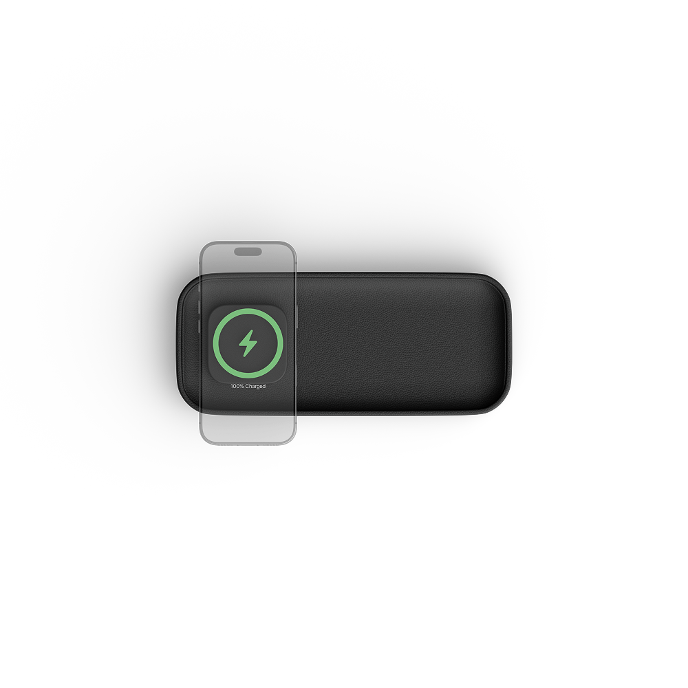 A black rectangular charger with rounded corners, shown from a top-down view on a white background. A smartphone is partially overlaid on the left side, and the charger has a green circular charging icon printed on it.