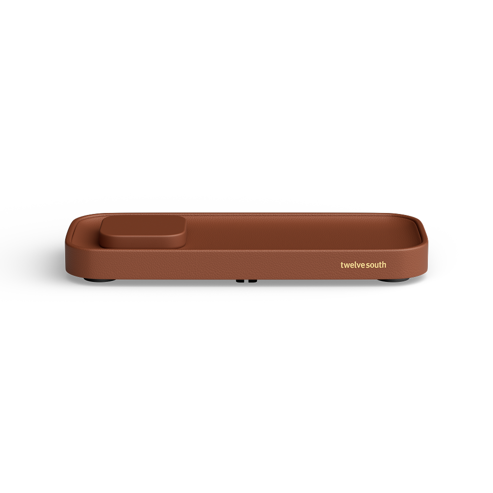 A brown rectangular valet charging tray with rounded corners and a small recessed compartment on one end, shown on a clean white background. The brand name 'twelve south' is printed in gold near the right side.