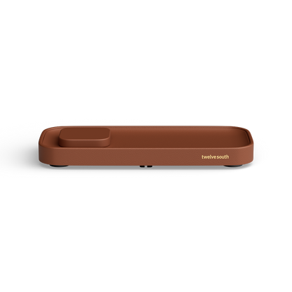 A brown rectangular valet charging tray with rounded corners and a small recessed compartment on one end, shown on a clean white background. The brand name 'twelve south' is printed in gold near the right side.