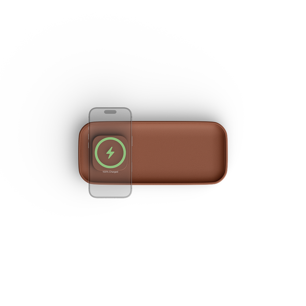 A brown rectangular wireless charging pad with rounded corners, shown from a top-down view on a white background. A smartphone is placed on top of the pad, with a green and white 'WARP CHARGE' logo visible on the pad's surface.
