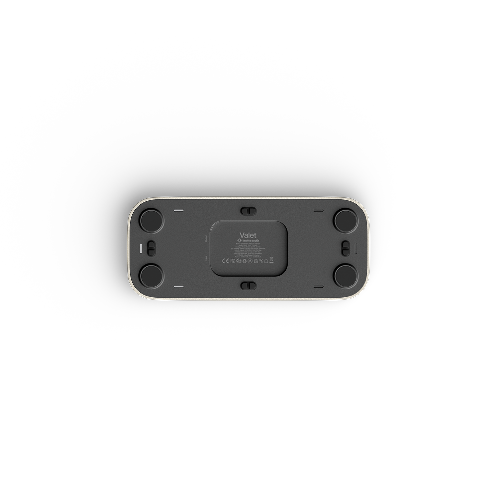 The underside of valet, showing the internal cartridge housing, side ports, and circular feet, photographed on a clean white background.