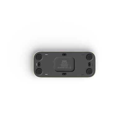 The underside of valet, showing the internal cartridge housing, side ports, and circular feet, photographed on a clean white background.